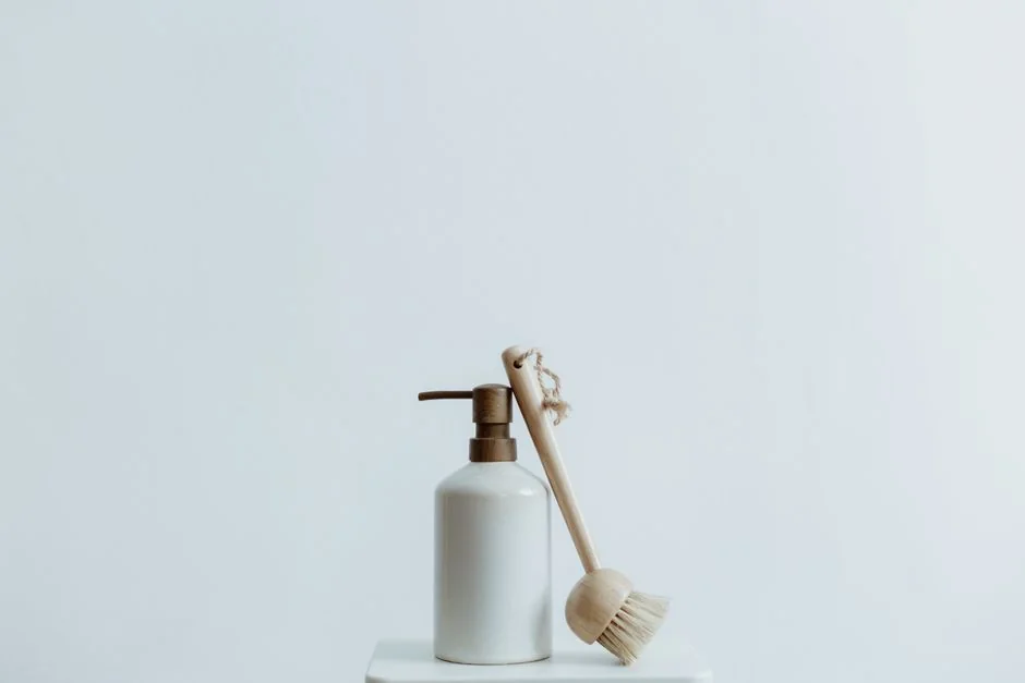 A chambermaid arranges pillows in a luxurious hotel room, showcasing comfort and elegance.