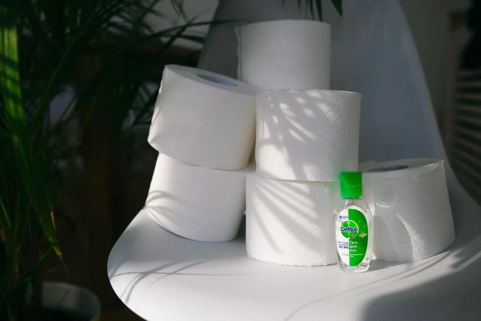 A professional housekeeper organizing pillows in a luxurious hotel room, maintaining service quality.